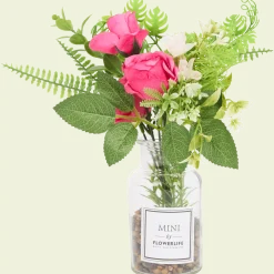 Kunstbloemen in glazen fles